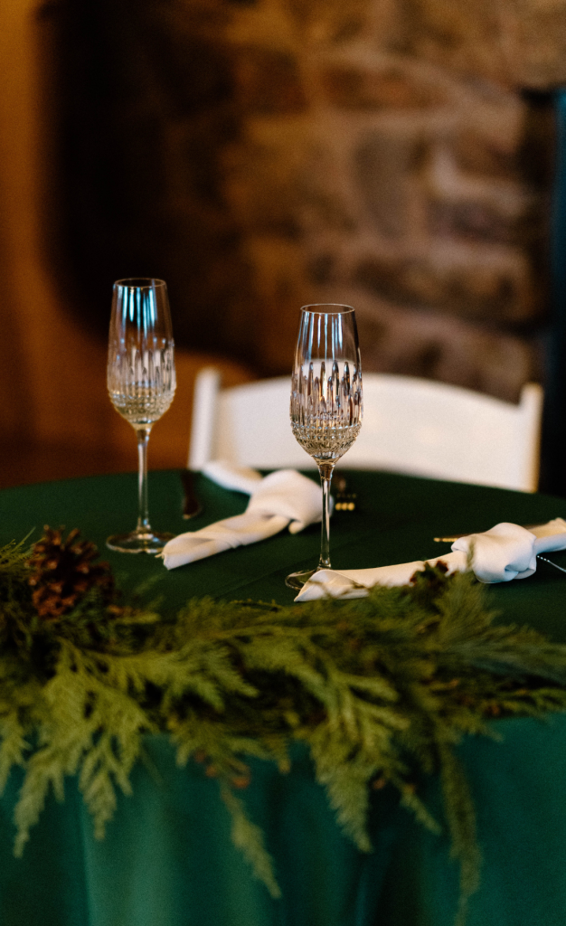 Sweetheart table with champagne flutes and winter florals