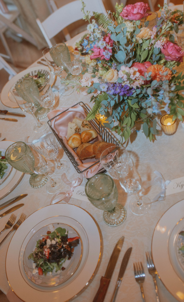 Table setting with colored glassware and colorful floral