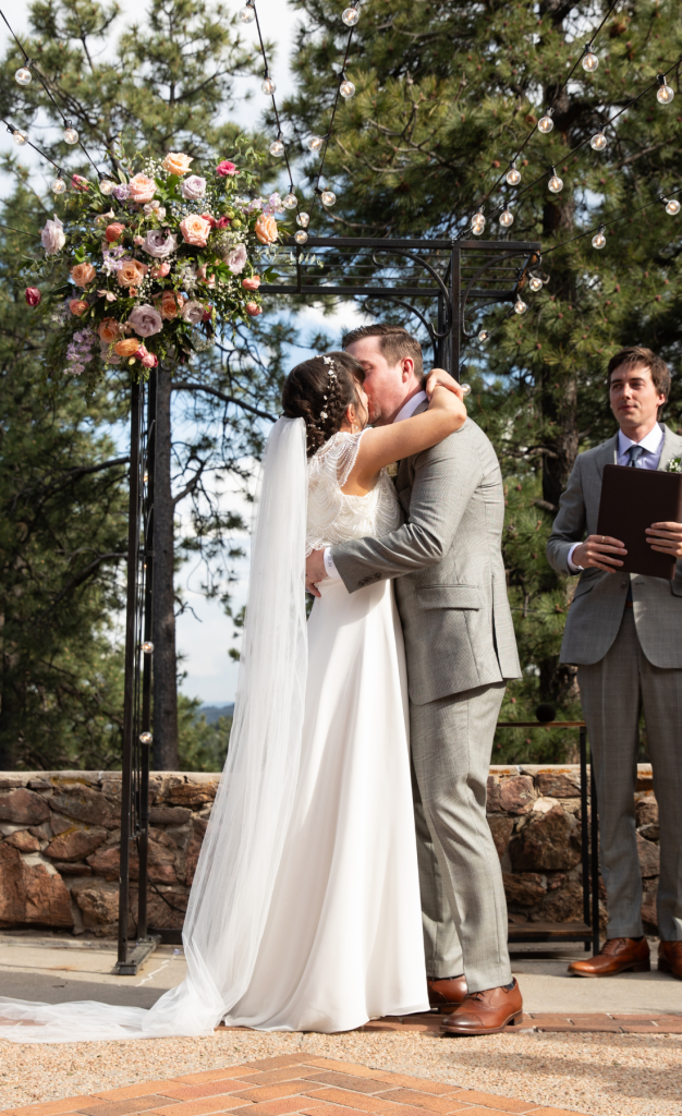Bride and groom kissing during wedding ceremony