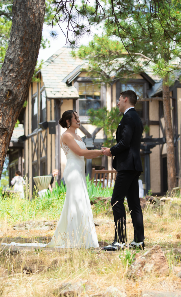 Bride and groom in front of old building