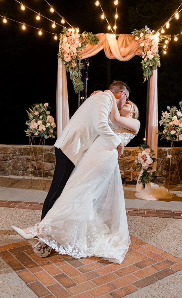 Groom kissing bride during first dance