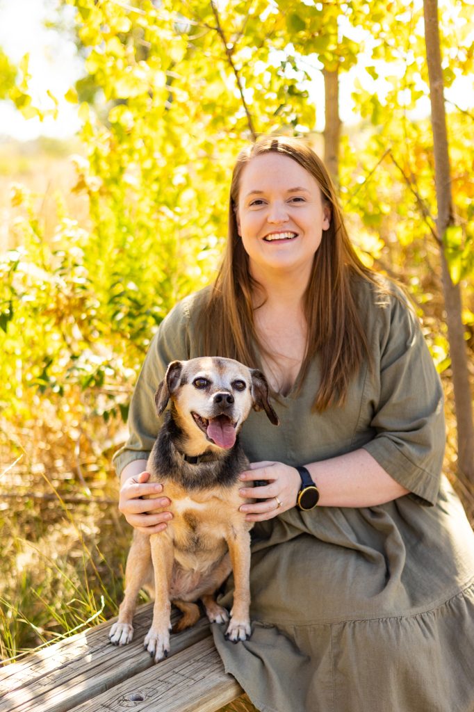 Woman in green dress with small dog